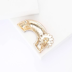 Detailed back view of a golden rainbow brooch showing the pin buckle and metal structure