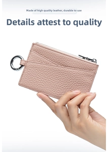 Close-up of pink litchi grain leather card holder with silver zipper and secure stitching