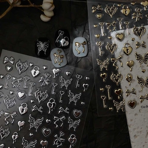 Macro detail of 3D embossed gold and silver star moon nail art stickers with metallic texture