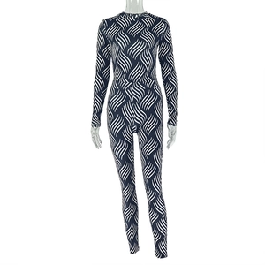 Close-up of navy and white wave pattern fabric on a fitted long sleeve jumpsuit