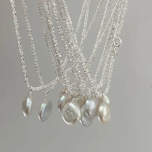 Close-up of baroque freshwater pearl pendant on a sparkling S925 sterling silver chain