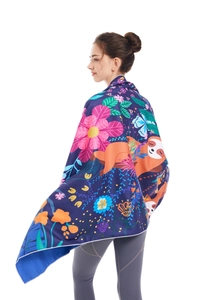 Detail view of double-sided microfiber beach towel with tropical sloth and floral print