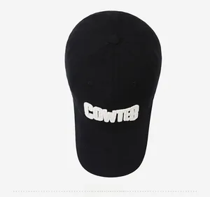 Detailed top view of black cotton baseball cap with white 3D COWTEB embroidery