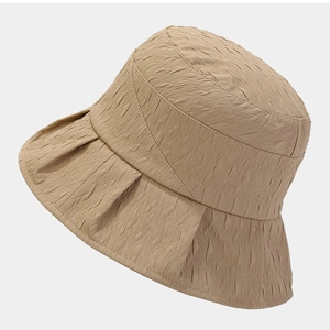 Chic beige crinkle fabric bucket hat with a wide brim for sun protection, side 45-degree view