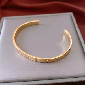 18K gold plated cuff bracelet with star engraved crystals and polished finish