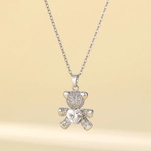 Silver bear pendant necklace with heart-shaped stone and micro-pave zirconia in titanium steel