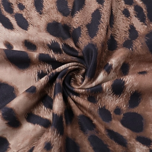 Macro detail of leopard print fabric showing the smooth texture and brown pattern