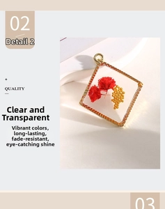 Close-up of square gold pendant with red dried flowers and clear resin detail