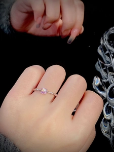 Close-up of S925 silver ring with a pink square-cut gemstone worn by a model