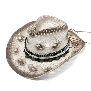 Close-up of hand-woven cowboy hat with blue beads, metal discs and gradient brim