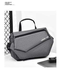 Detail of gray techwear crossbody bag with black handle and white FASHION lettering