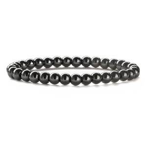 Detailed view of polished hematite stone beads with metallic finish on elastic bracelet