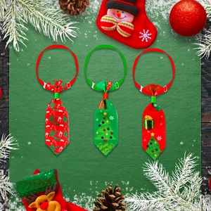 Flat lay of three Christmas pet ties with festive patterns on a dark green background