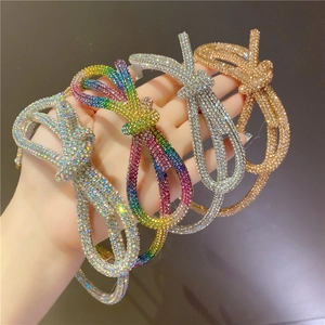 Handmade headband with sparkling colorful rhinestones in a twisted bow design