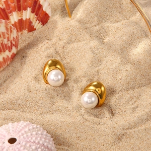 18K gold plated stainless steel pearl stud earrings on a beach sand background