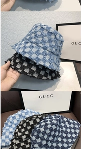 Detail of checkered bucket hats featuring frayed edges and vintage denim canvas texture