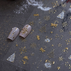 Self-adhesive gold and white Christmas nail stickers with snowflakes and trees designs