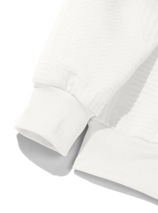 Detailed macro view of white waffle knit texture and ribbed cuffs on men's hoodie
