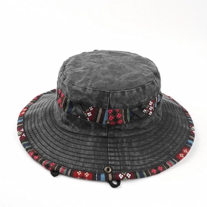 Detail of dark grey washed canvas bucket hat with ethnic woven trim and metal snap button