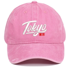 Pink washed cotton baseball cap with Tokyo embroidery in a minimalist studio view