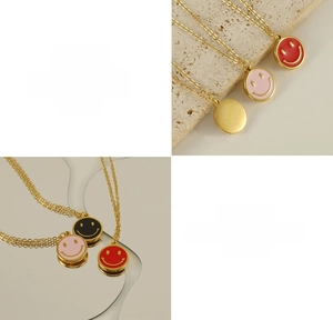 Macro details of smiley face pendants in pink, black, red, and gold stainless steel