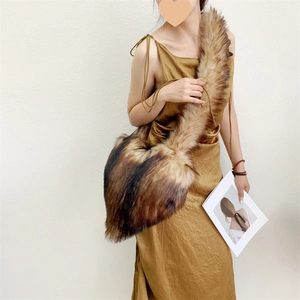 Detailed view of the long faux fur texture and natural color gradient of the heart shell bag