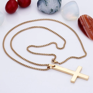Detailed view of a gold-plated stainless steel cross pendant on a classic box chain