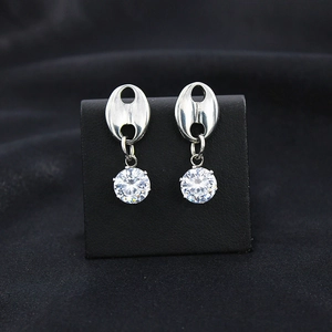 Close-up of silver pig-nose stud earrings with sparkling round cubic zirconia drops
