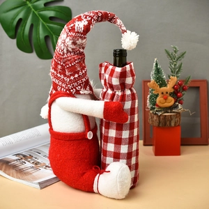 Christmas gnome wine bottle cover in red and white knit fabric for festive table decor