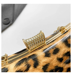 Macro view of leopard print clutch with rhinestone-encrusted gold metal clasp