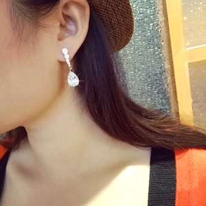 Elegant silver pear-shaped drop earrings with AAA cubic zirconia on female model