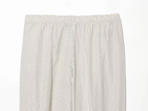 Detailed view of elastic waistband and black and white checkered fabric of trousers