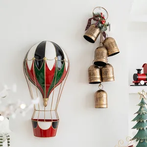 Christmas hot air balloon wall hanging and vintage metal bell set with pine cones and berries