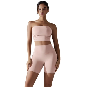 Women's ruched bandeau top and high-waisted lift yoga shorts set in dusty pink