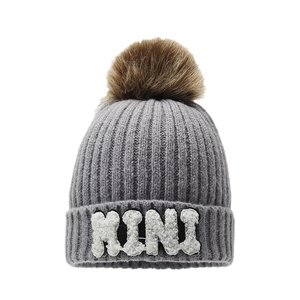 Grey knit beanie with brown fur pom pom and white MINI letter patch for winter outdoor wear