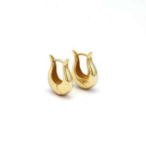 Minimalist gold sterling silver hoop earrings with a sleek curved heavy metal design