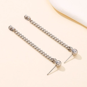 Detail of silver stainless steel long curb chain drop earrings with polished ball studs