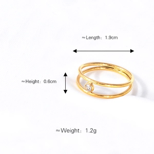 Minimalist double-layer gold titanium steel ring with zircon gemstone on white fabric
