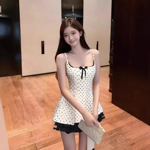 French chic polka dot dress with lace trim and bow detail in a full body shot