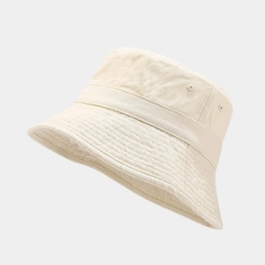 Detail of beige cotton bucket hat showing reinforced stitching and metal eyelets