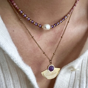 Double-layered 14K gold necklace with purple beads, pearl, and sunburst pendant