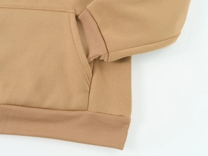 Detail view of khaki knitted hoodie showing ribbed cuffs and kangaroo pocket stitching