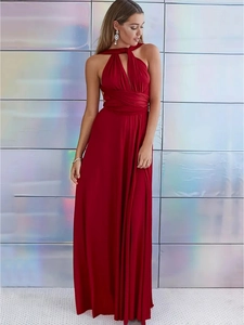 Detalle de vestido largo rojo con cuello halter y lazos cruzados en la cintura para mujer