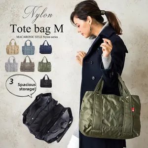 Detail view of military green nylon tote bag featuring a triple compartment interior design