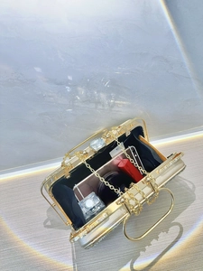 Detail of gold evening clutch opening with jewel buckle and rhinestone-lined edges