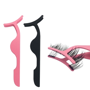 Detail of pink and black magnetic eyelash applicators showing functional usage on lashes
