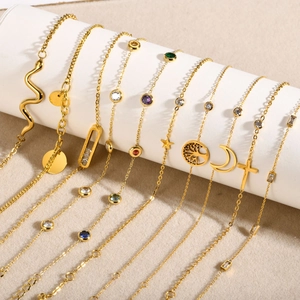 Macro view of gold-plated stainless steel chains with colorful zircon and geometric charms