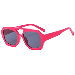 Pink oversized geometric sunglasses with dark grey UV lenses in a 45-degree angle view