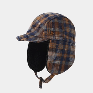 Close-up of boys distressed plaid trapper hat with warm faux fur lining and chin strap