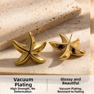 Macro view of gold starfish stud earrings with a polished vacuum-plated finish